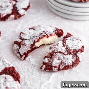 Red velvet crinkle cookie with a rich cheesecake filling visible.