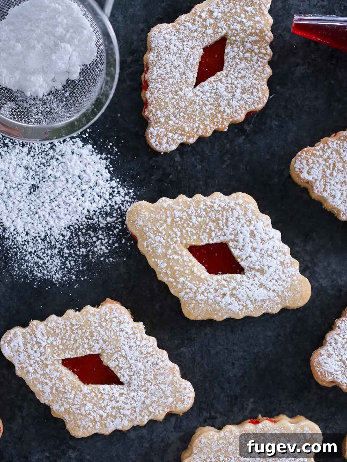 24 Irresistible Christmas Cookies 30 Diamond shaped Linzer cookies, elegantly dusted with powdered sugar.