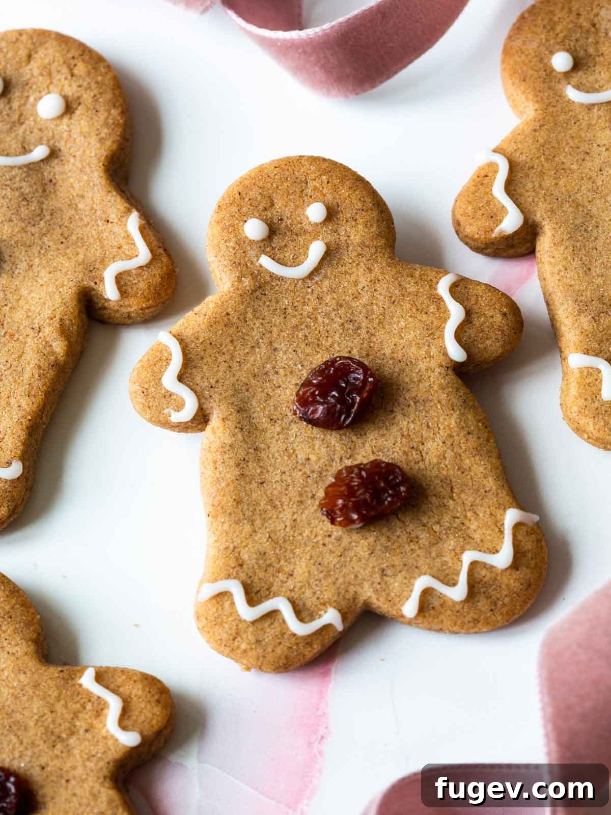 24 Irresistible Christmas Cookies 4 Gingerbread cookie with elegant white icing and raisin decorations.