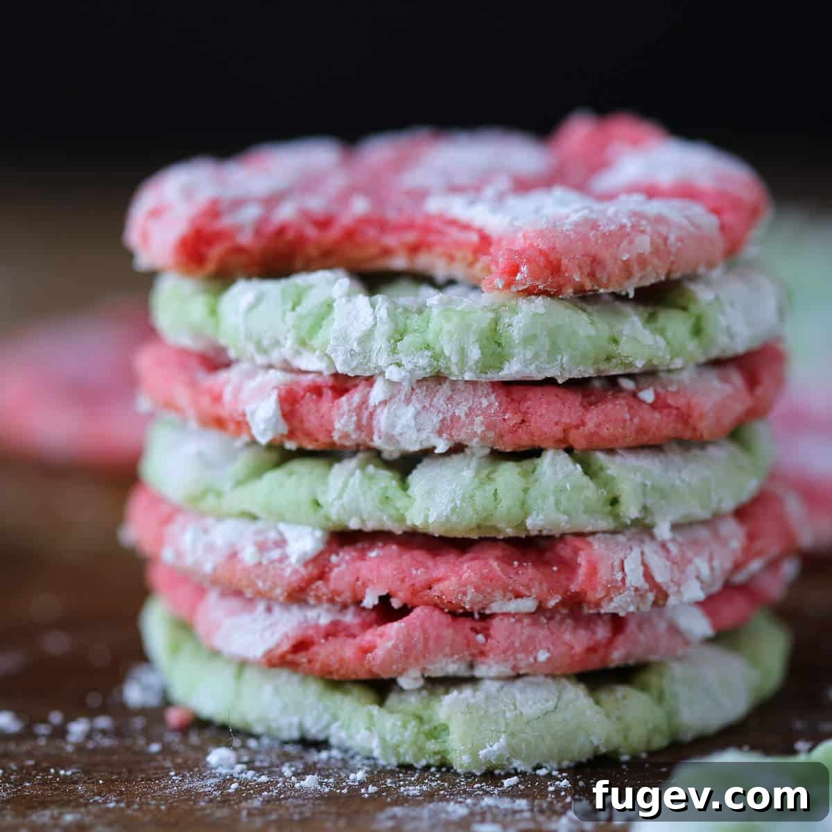24 Irresistible Christmas Cookies 42 Festive Almond Crinkle Cookies, stacked to show their interior texture and powdered sugar coating.