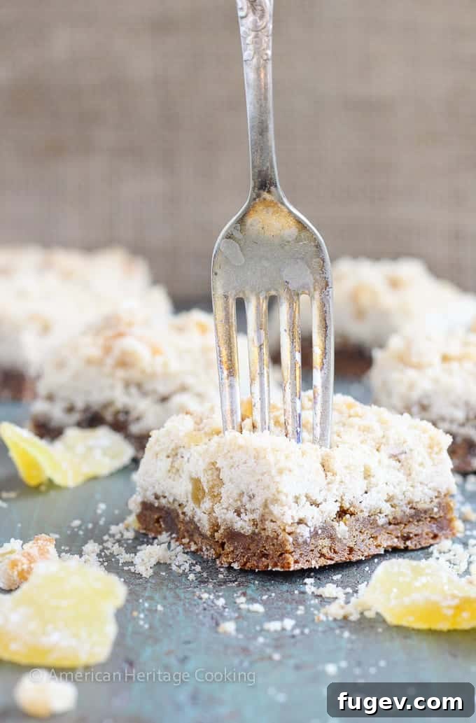 24 Irresistible Christmas Cookies 48 Chewy ginger bars with a fork, showing their tender texture.