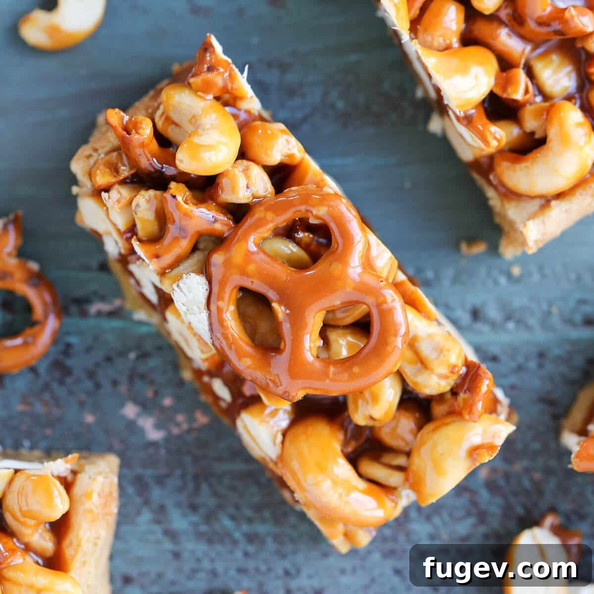 24 Irresistible Christmas Cookies 50 Cashew Caramel Pretzel Blondies on a teal wooden surface.
