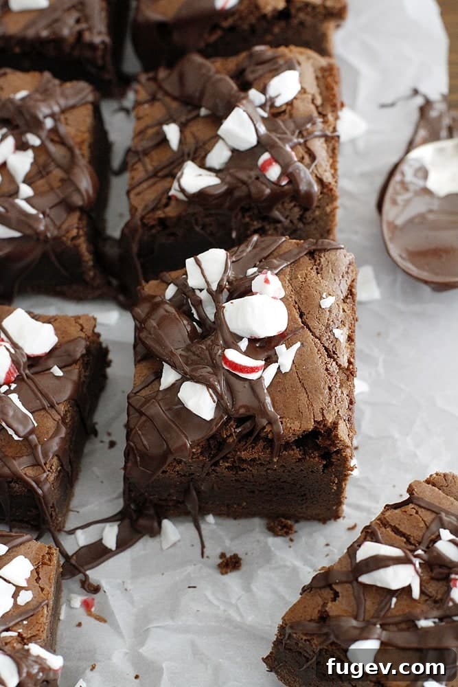 24 Irresistible Christmas Cookies 54 Sliced peppermint brownies on parchment paper, ready to serve.