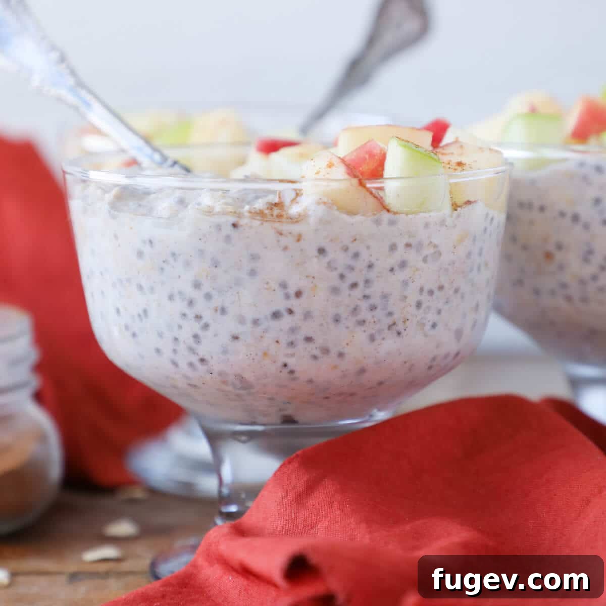 Cozy Apple Pie Overnight Oats 3 Close-up shot of Apple Pie Overnight Oats in a glass jar, showcasing its creamy texture with visible oat flakes and apple pieces.