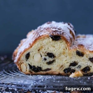 Stollen Delicious Sideview - A perfectly sliced Stollen showing its rich interior and powdered sugar coating.