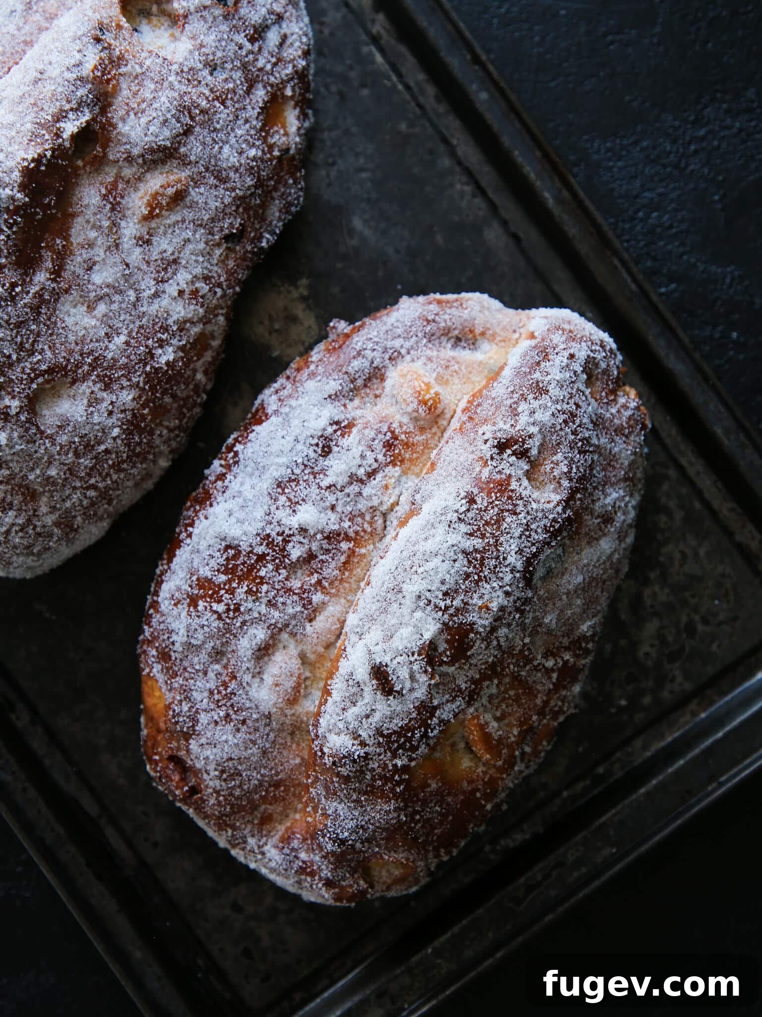 Bake the Perfect Holiday Stollen 5 Holiday Loaf Overhead - An overhead shot of a freshly baked Stollen, dusted with powdered sugar, ready to be served during the holidays.