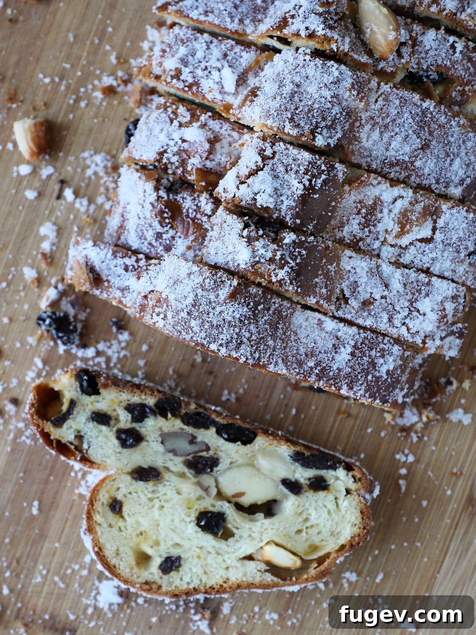 Bake the Perfect Holiday Stollen 6 Stollen Wood Cutting Board - A festive Stollen loaf resting on a rustic wooden cutting board, adorned for the holidays.