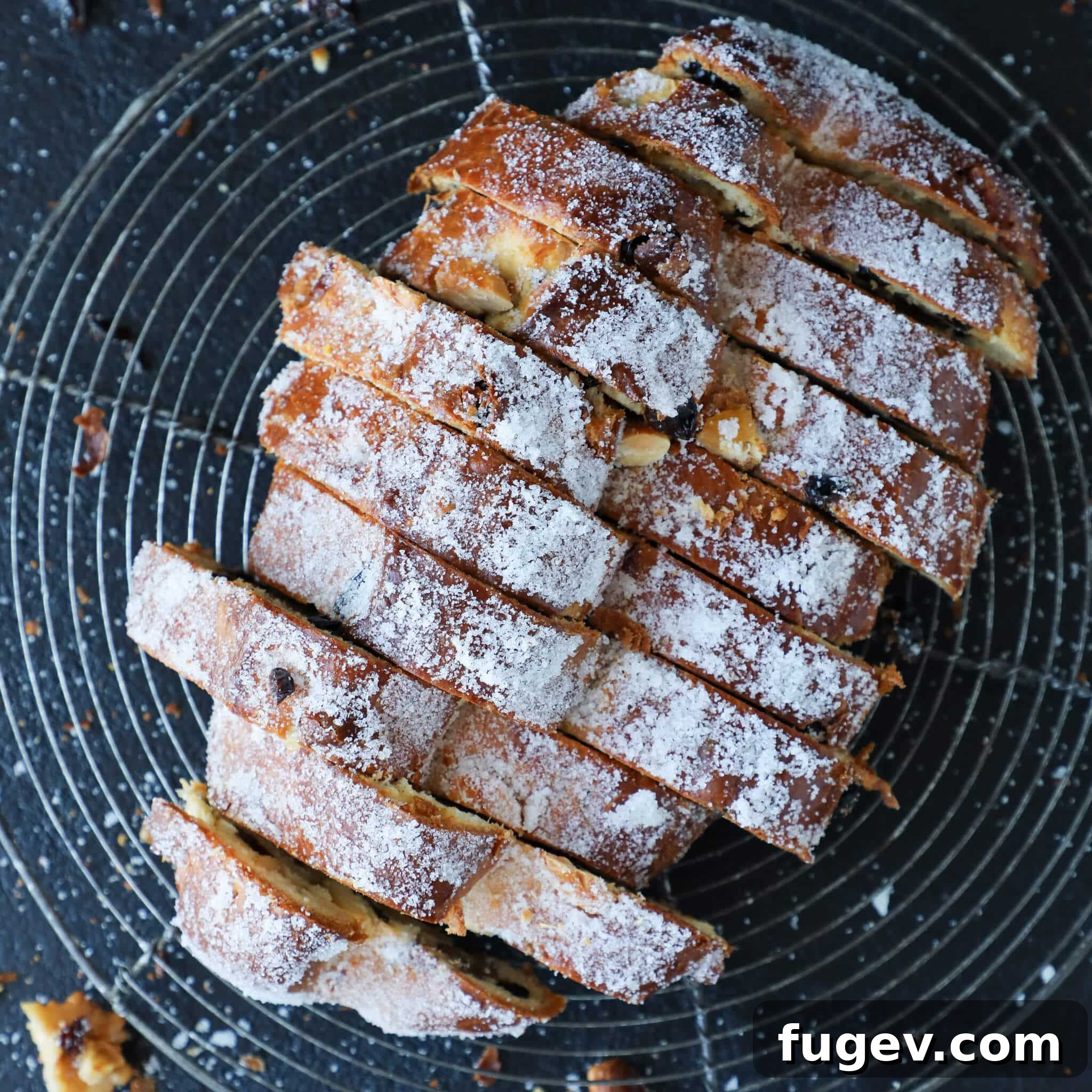 Bake the Perfect Holiday Stollen 7 Holiday Loaf Wire Rack - Stollen bread cooling on a wire rack, highlighting its golden crust and preparation for final dusting.