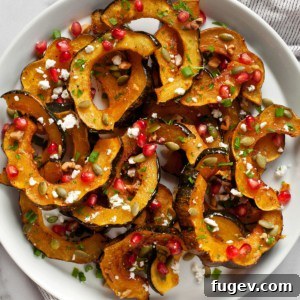 Maple acorn squash with pomegranate seeds, goat cheese and pumpkin seeds.