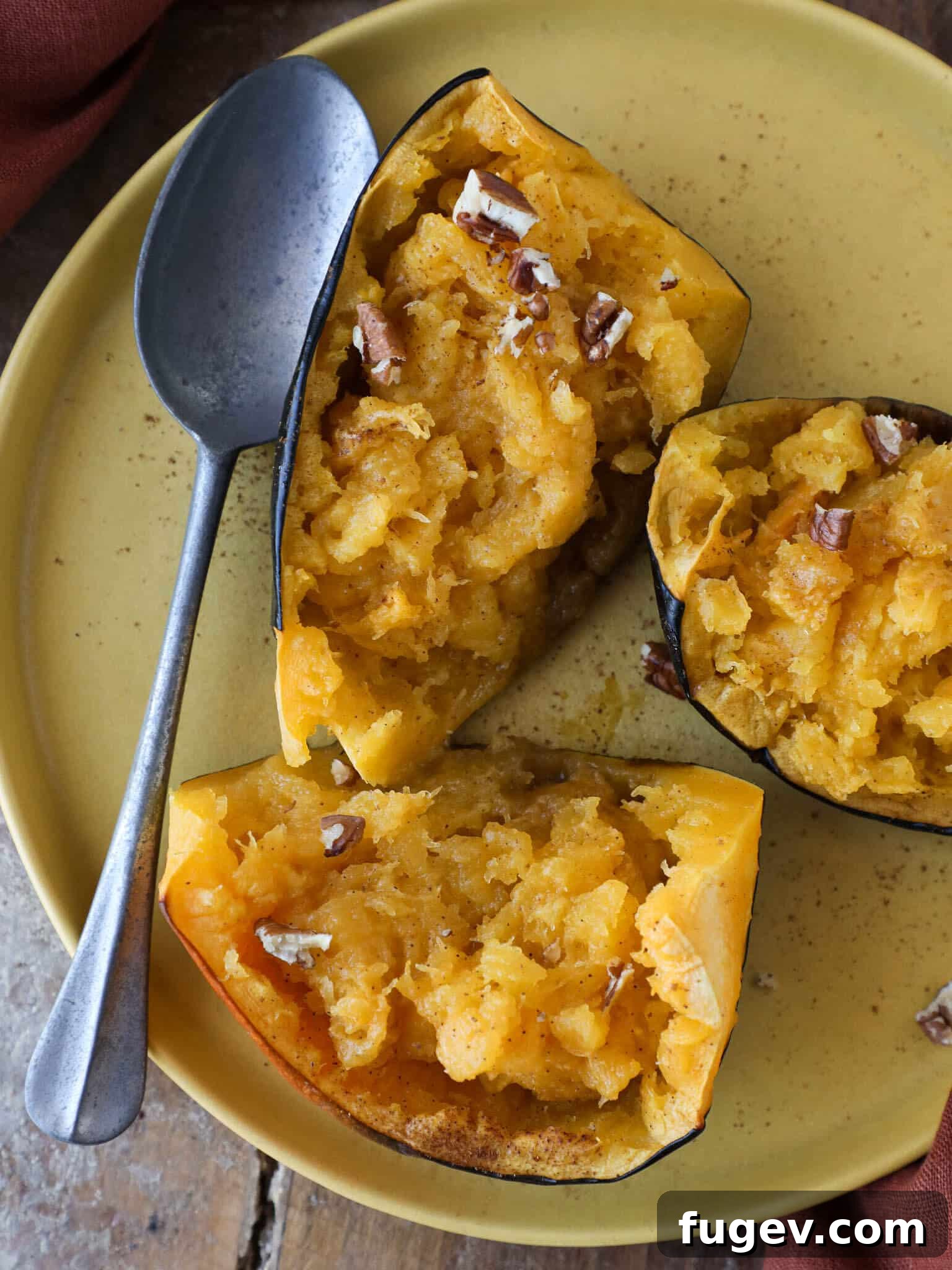 Golden Baked Acorn Squash 2 Brown Sugar Baked Acorn Squash with Silver Spoon, ready to serve