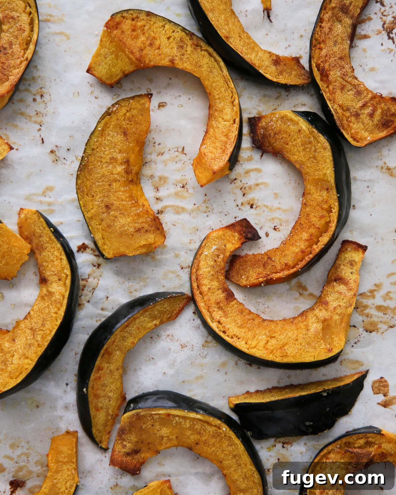 Caramelized Acorn Squash Slices 4 Healthy Roasted Acorn Squash Baked with spices on a baking sheet, ready for the oven.