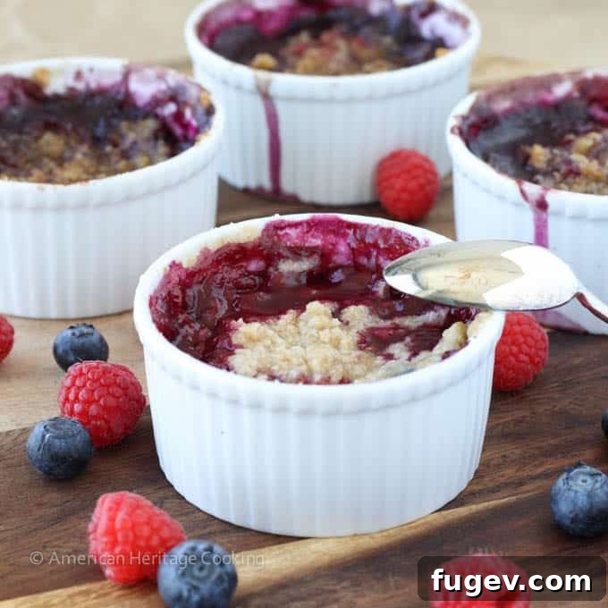 Sweet Blueberry Raspberry Crumble Cups 6 Freshly baked individual crumbles on a wire rack, cooling down.