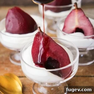 Easy Red Wine Poached Pear Dessert with sauce pouring, a beautiful and light Valentine's treat.