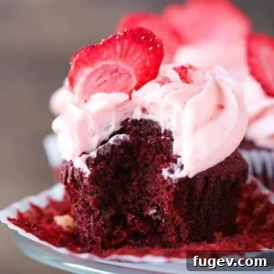 Red Velvet White Chocolate Cupcake unwrapped closeup, showcasing its rich texture.