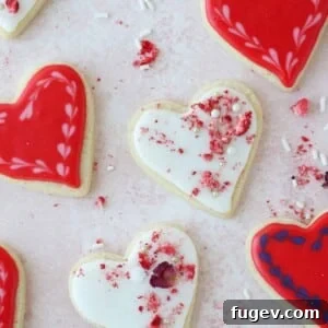 White and red heart cookies with pink strawberries and rose petals, a lovely Valentine's Day gift.