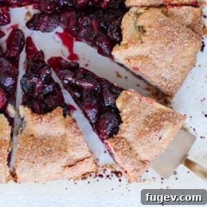 Cherry Galette with Almond Buttermilk Crust, baked and sliced on parchment.