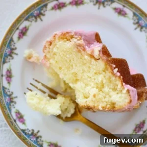 Lemon Pound Cake with Strawberry Icing on vintage china, a beautiful and flavorful dessert.