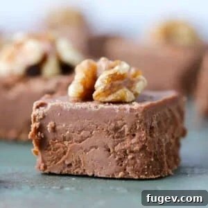 Sliced fudge square with walnut on top, a classic and indulgent candy.