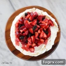 Lemon Berry Pavlova Cake, a light, crisp, and fruity gluten-free option.
