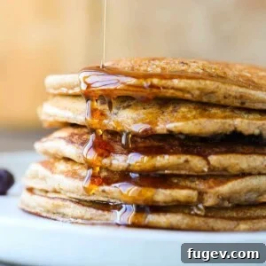 Whole wheat pancakes stacked with maple syrup, a wholesome and comforting breakfast.