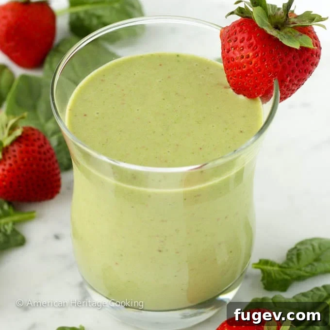 Sweet Green Power Smoothie 2 Vibrant Strawberry Banana Spinach Smoothie in a glass, ready to be enjoyed.