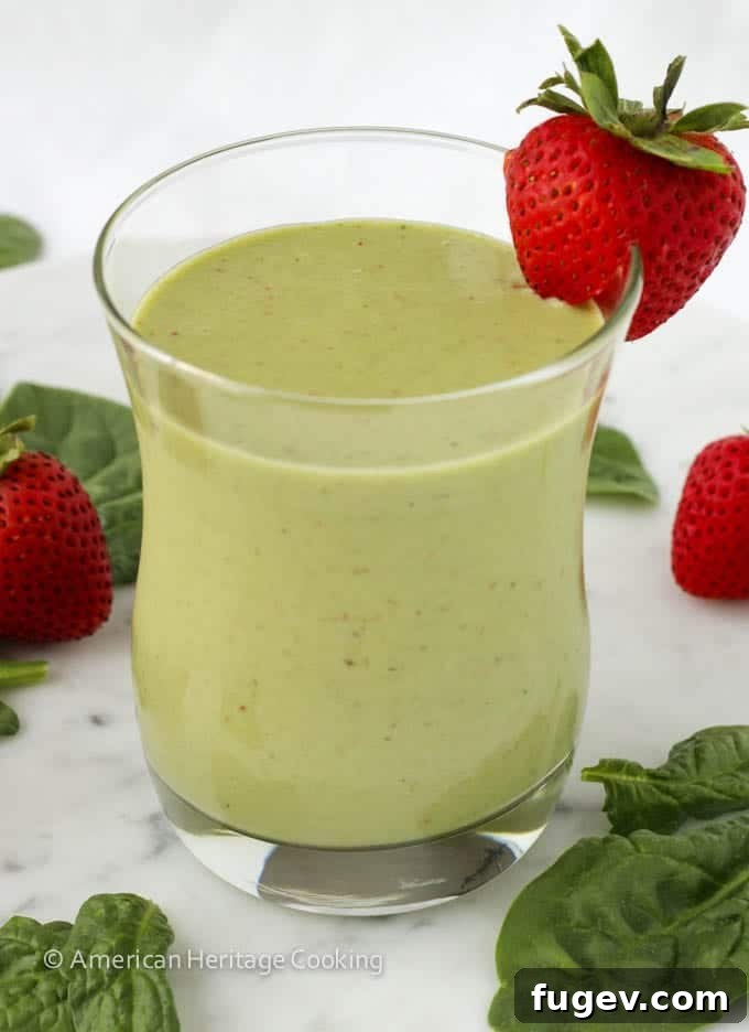Sweet Green Power Smoothie 5 Top-down view of the Strawberry Banana Spinach Smoothie, garnished with a fresh strawberry.