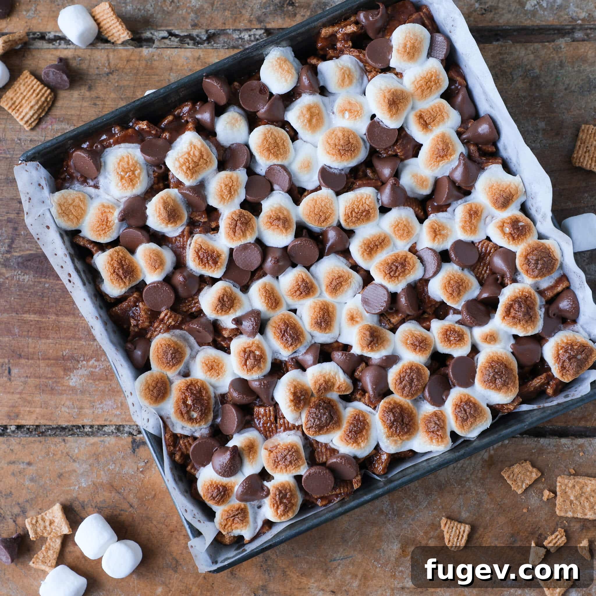 No Bake Golden Graham Smores Treats 2 No Bake Golden Graham Smores Bars uncut in vintage baking pan, showcasing their golden-brown topping.