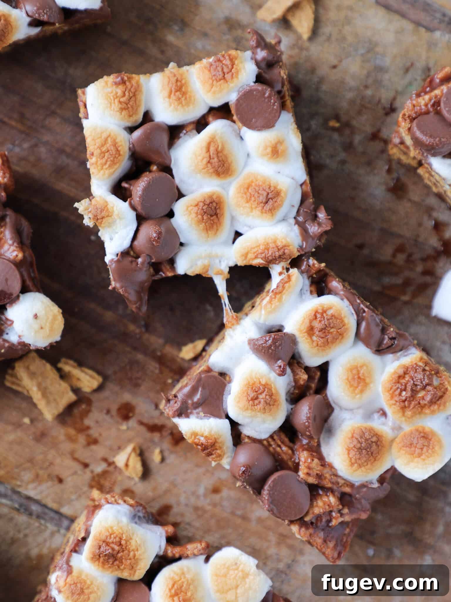 No Bake Golden Graham Smores Treats 4 No Bake Golden Graham Smores Bars sliced, showing a delightful marshmallow pull when separated.