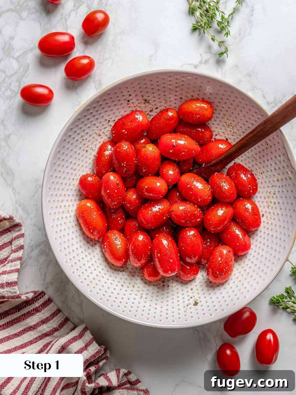 Golden Zucchini Fritters Delight 5 cherry tomatoes in bowl with oil and seasoning.