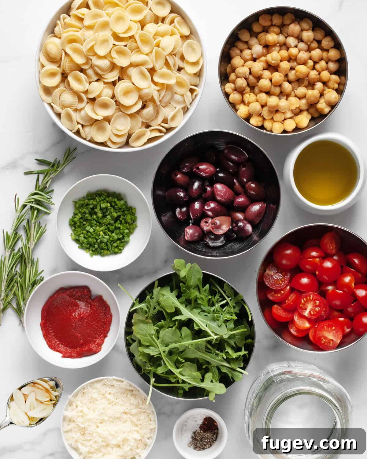 Mediterranean One Pan Orecchiette 3 Ingredients including orecchiette, chickpeas, olives, tomatoes, arugula, parmesan, tomato pasta, garlic and water.