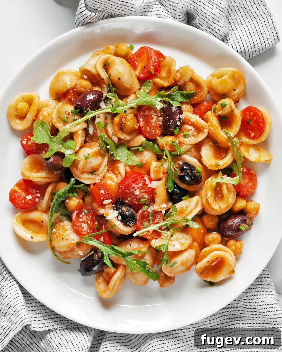 Mediterranean One Pan Orecchiette 6 One pan pasta with chickpeas, tomatoes and olives on a plate.