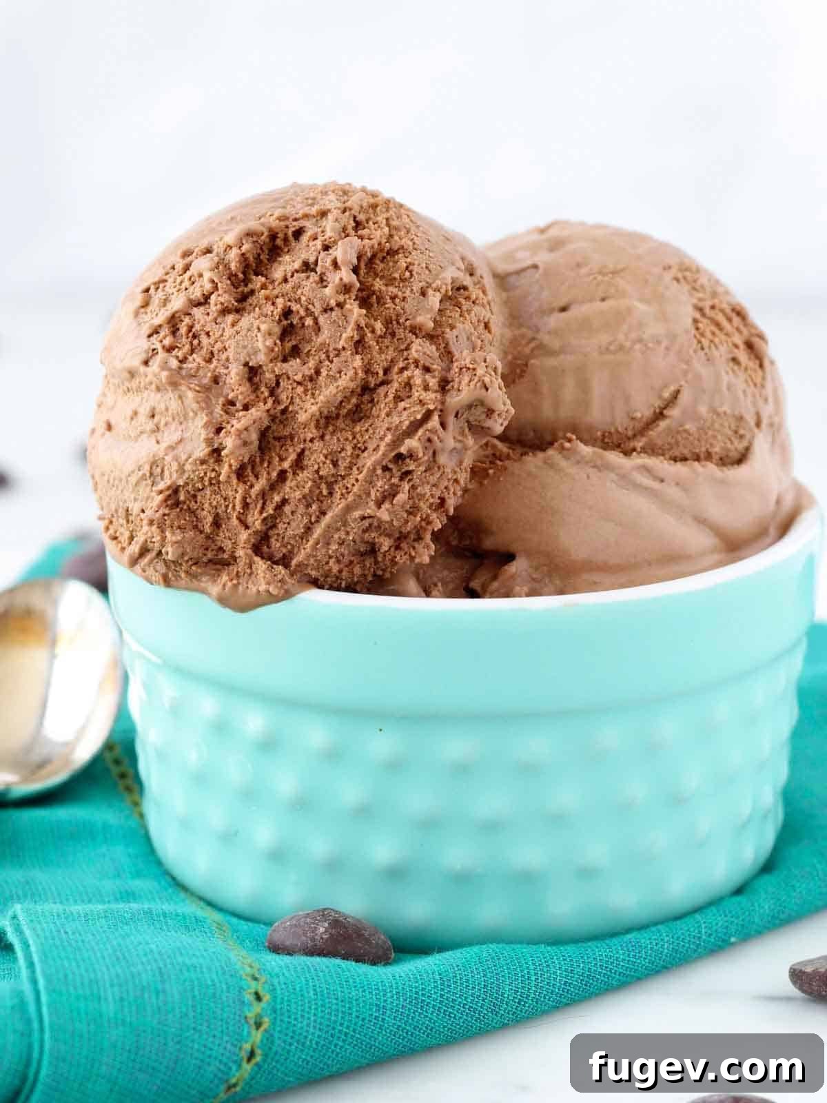 Decadent Chocolate Dream Ice Cream 3 Three scoops of rich chocolate ice cream in a beautiful teal bowl, garnished subtly.