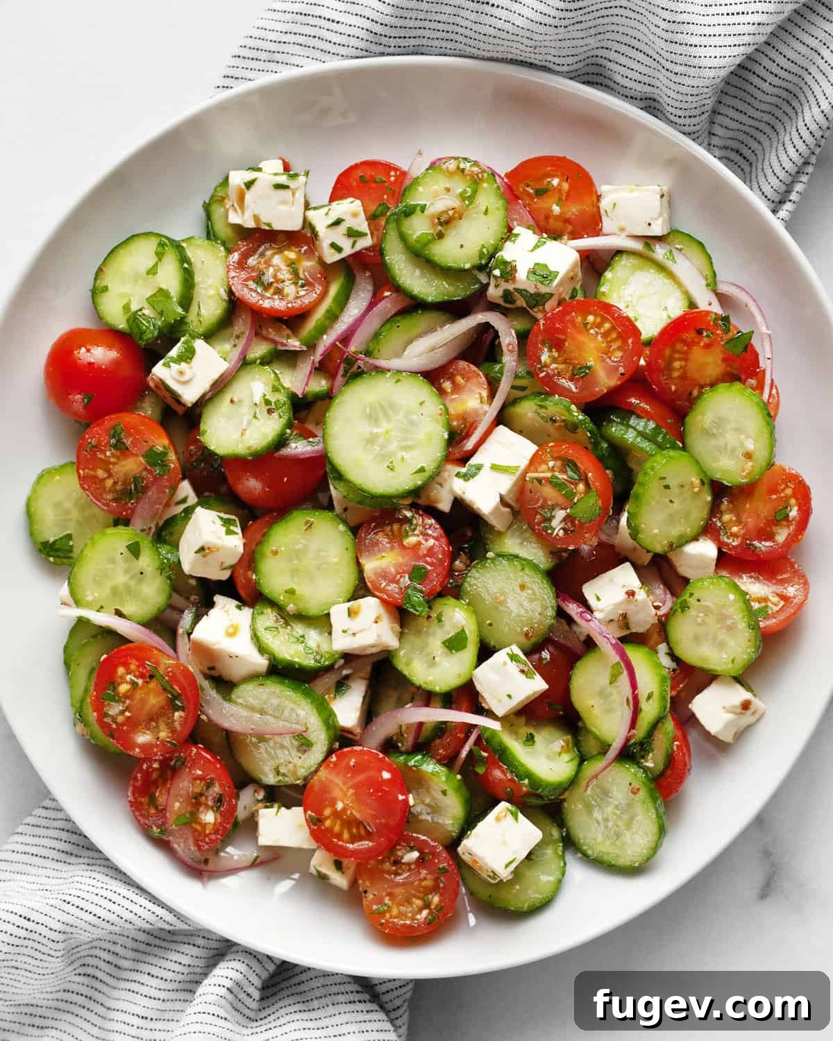 Mediterranean Feta Salad 2 Cucumber tomato feta salad on a plate, ready to be enjoyed.