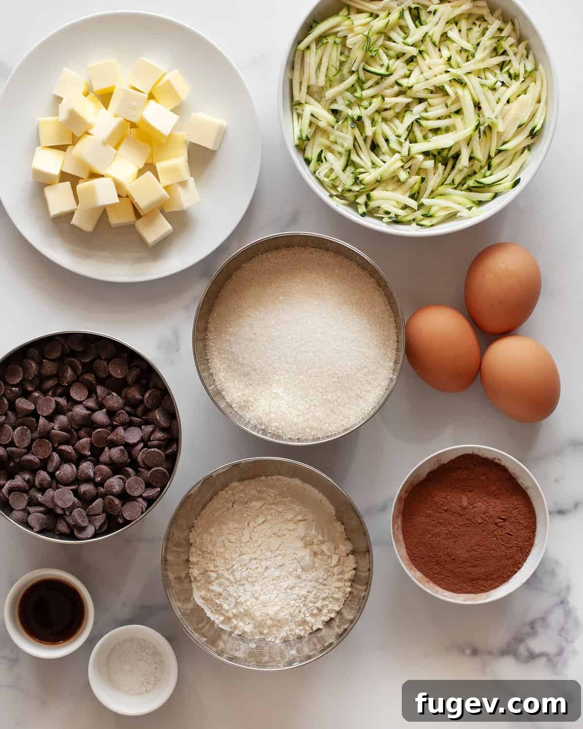 Sneaky Zucchini Brownie Bliss 3 A collection of ingredients laid out: semisweet chocolate chips, shredded zucchini, cubes of butter, granulated sugar, whole eggs, rich cocoa powder, and a pinch of salt.