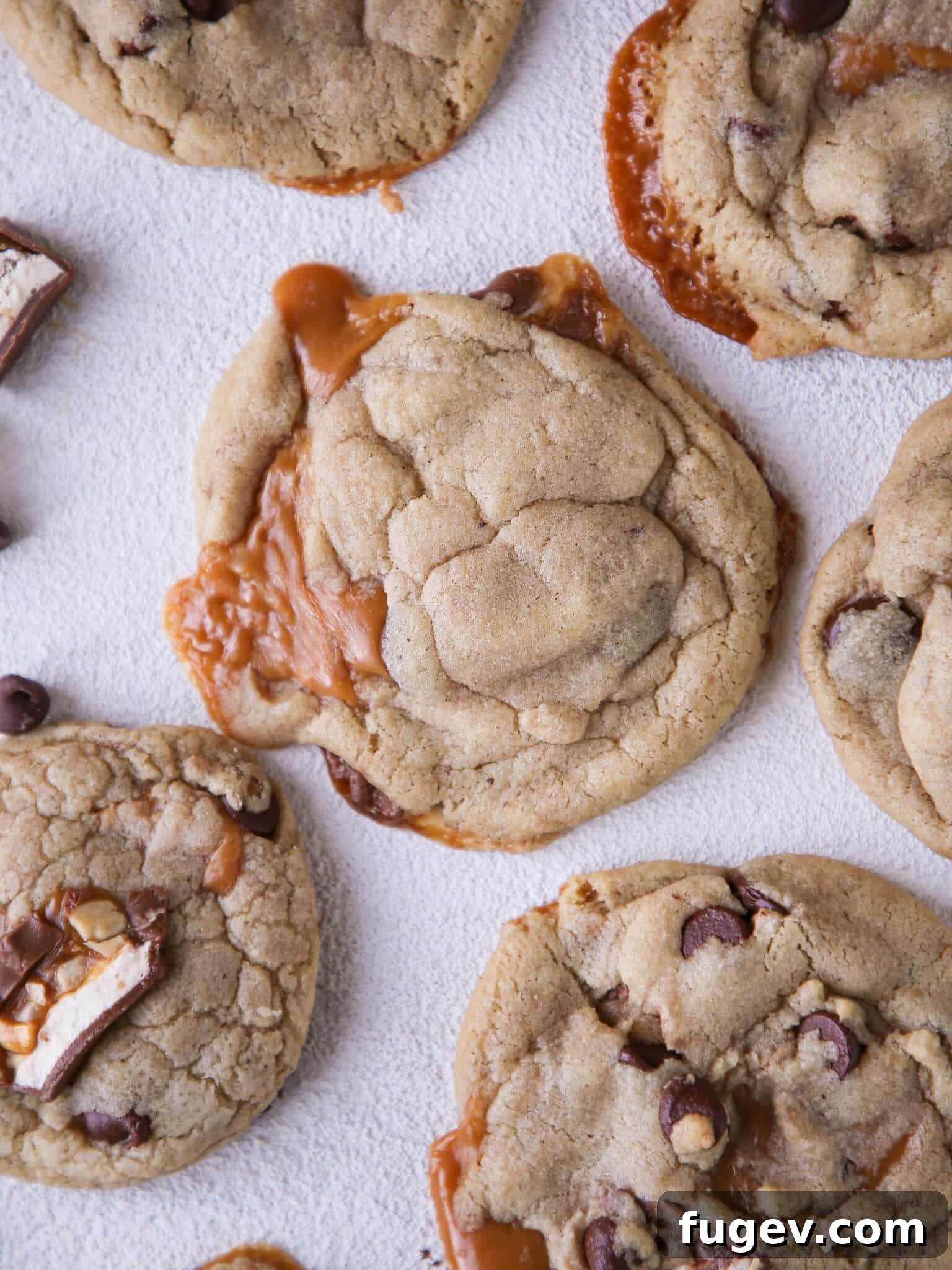 Molten Caramel Snickers Brown Butter Chocolate Chip Cookies 5 Caramel Stuffed Brown Butter Snickers Chocolate Chip Cookies with caramel spilling out