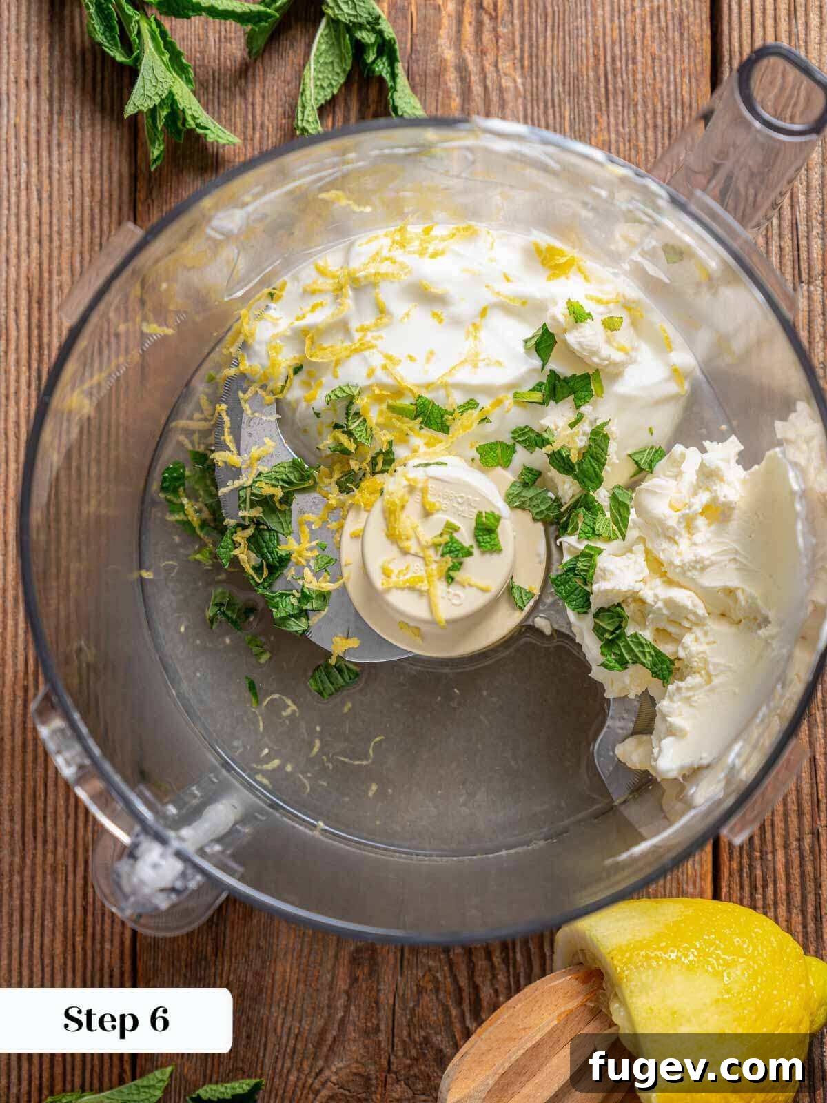 Succulent Chicken Burgers 9 Ingredients for the lemon-mint yogurt sauce being blended in a food processor.