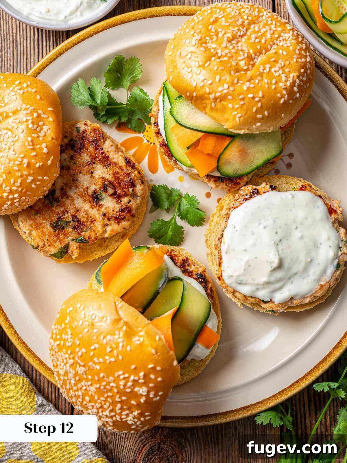 Succulent Chicken Burgers 10 A beautifully assembled chicken burger with sauce and salad on a plate, ready to be enjoyed.