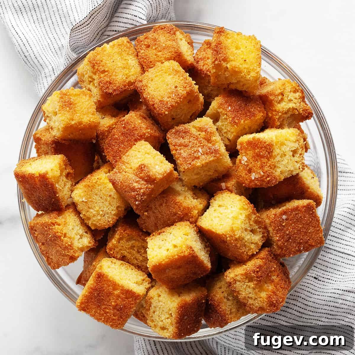 Golden Cornbread Bites 2 Golden brown cornbread croutons in a rustic bowl, ready to be served.
