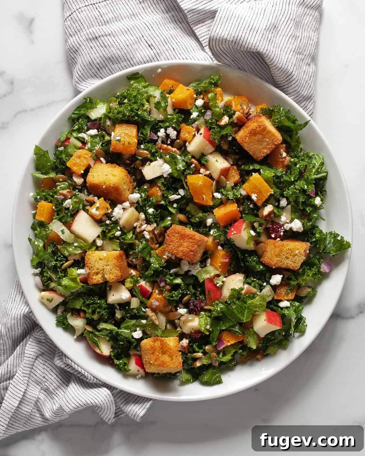 Golden Cornbread Bites 5 A vibrant fall harvest salad topped with cornbread croutons on a serving plate.