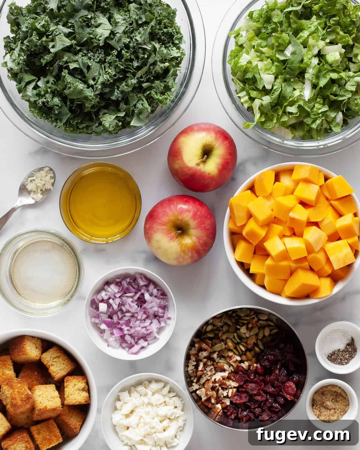 Golden Autumn Harvest Salad 3 Ingredients including kale, romaine, butternut squash, apples, pecans, goat cheese, apple cider vinegar and olive oil.