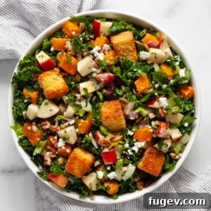 Fall salad with roasted butternut squash and apples in a bowl.