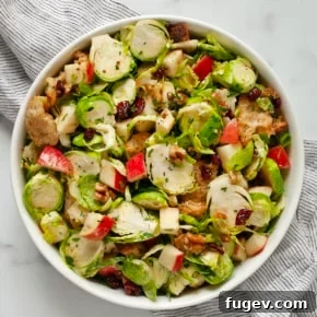 20 Fresh & Festive Thanksgiving Salad Recipes 13 Brussels sprout salad with apples, walnuts, dried cranberries and croutons in a bowl.