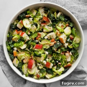 20 Fresh & Festive Thanksgiving Salad Recipes 14 Kale brussels sprout pear salad in a bowl.