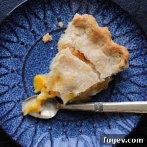 Old Fashioned Peach Pie sliced with a vintage gold fork