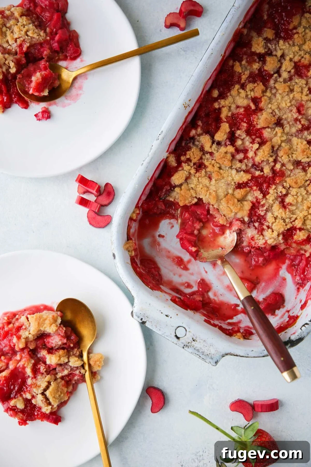 Effortless Summer Sweet Treats 30 Strawberry rhubarb crumble on white plates with gold spoons