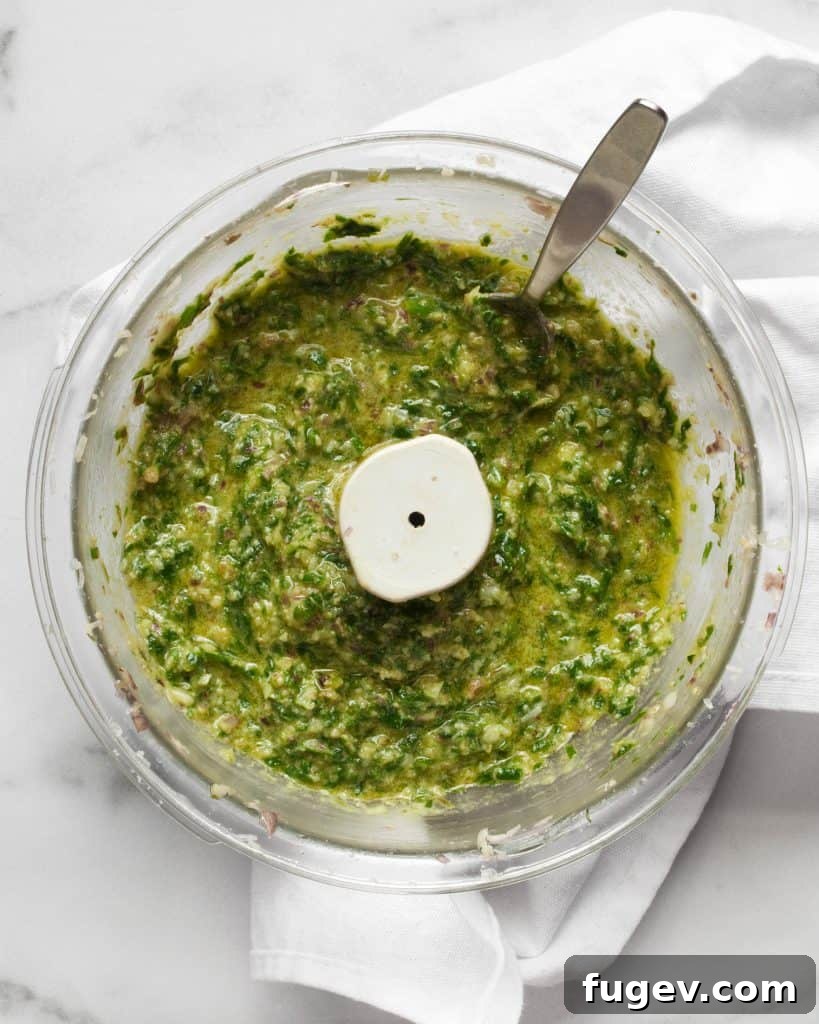 Spring's Emerald Ramp Sauce 4 The process of making ramp pesto in a food processor, showing a creamy green texture.