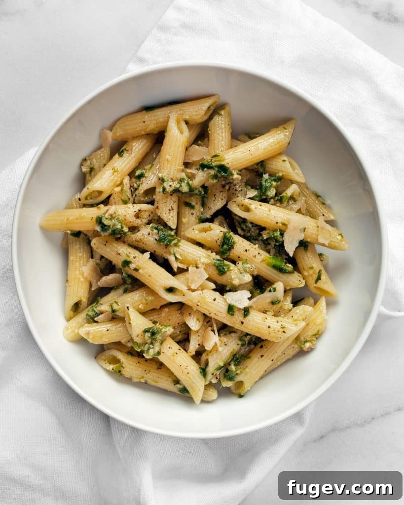Spring's Emerald Ramp Sauce 5 A close-up of pasta generously tossed with fresh ramp pesto and garnished with Parmesan cheese.