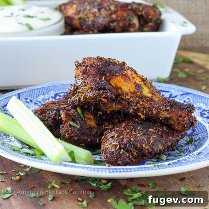 Crispy Baked Spice Medley Wings 4 Crispy baked chicken wings seasoned with a generous dry rub, served on a plate.