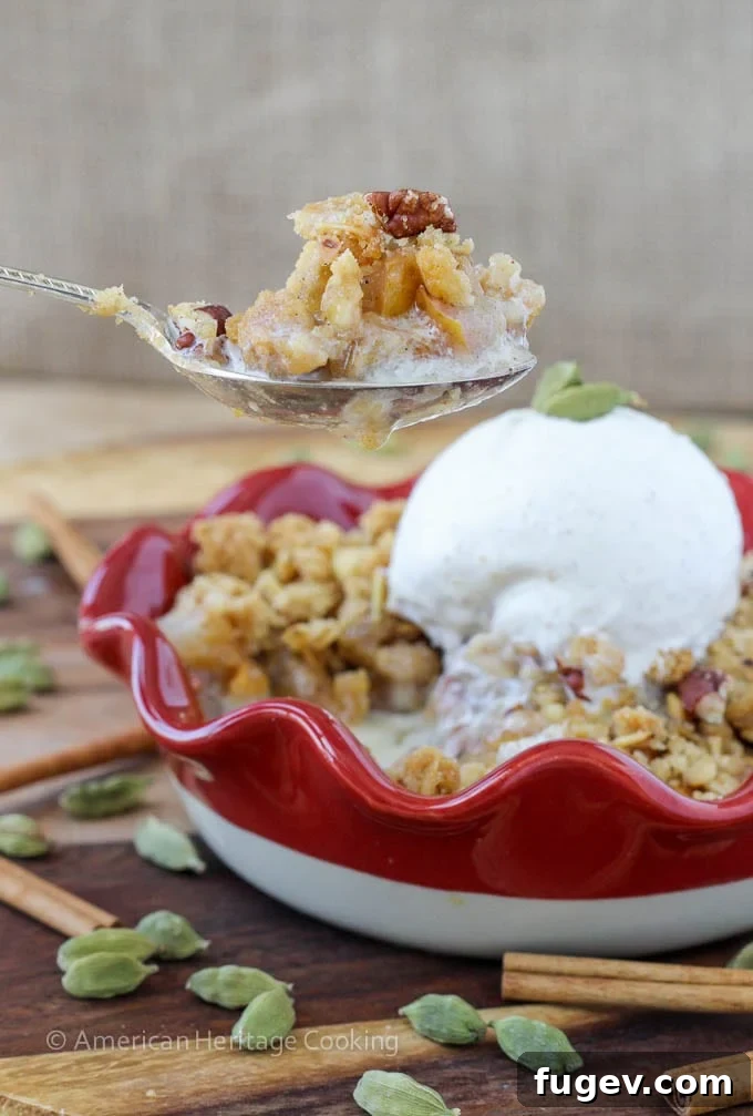 Fragrant Cardamom Pear Crumble 2 Delicious Cardamom Pear Crisp with a golden crumble topping, served in a small baking dish.