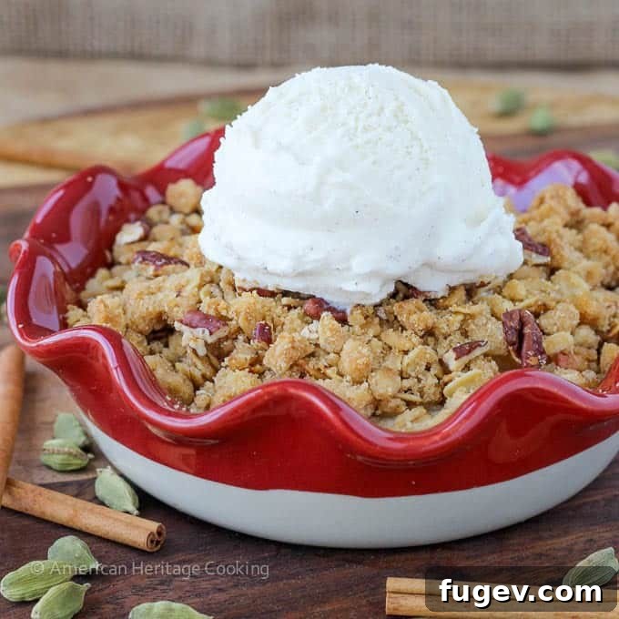 Fragrant Cardamom Pear Crumble 4 Individual serving of Cardamom Pear Crisp topped with a scoop of vanilla ice cream.